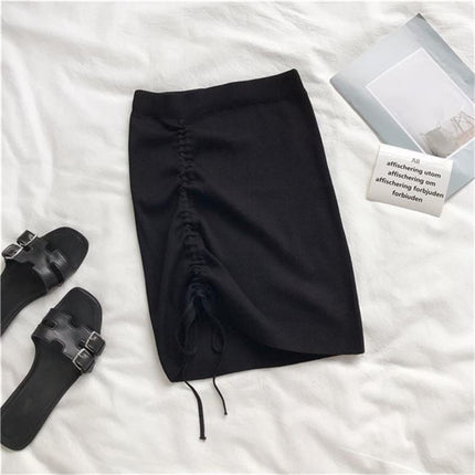 High waist black knitted women's skirt with drawstring detail, paired with sandals and styled on a light background.
