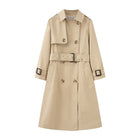 Beige trench coat with a belt on a white background