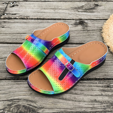 Colorful sandals with a buckle on a wooden surface