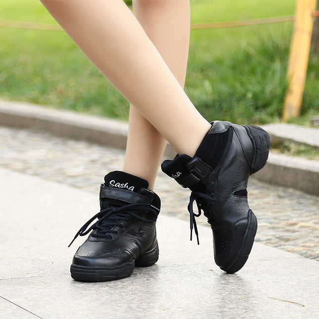 Black sneakers worn on a person's feet with a blurred outdoor background