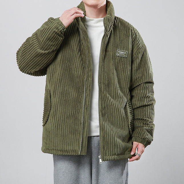 Person wearing a green corduroy jacket on a plain background