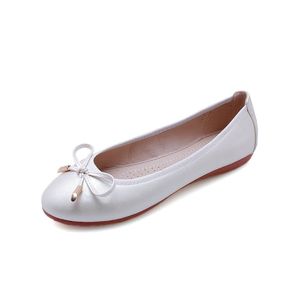 White flat shoe with a bow on a white background