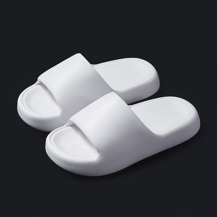 Pair of white slippers on a black background