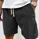 dark gray shorts with a white drawstring 