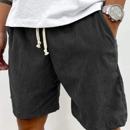 dark gray shorts with a white drawstring 