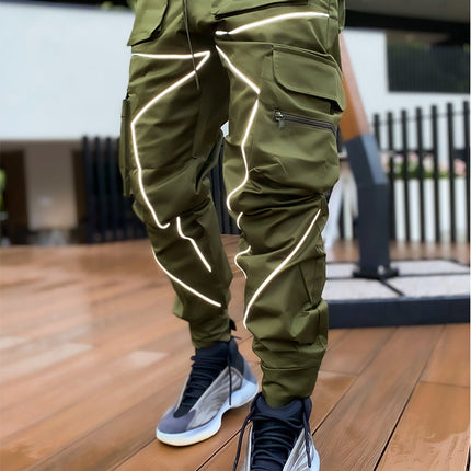 Person wearing green reflective pants on a wooden floor