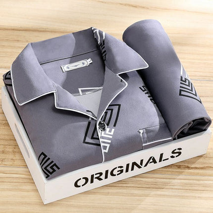 Folded gray shirt with brand logo on a white box labeled 'ORIGINALS' on a wooden surface