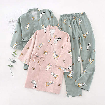 Pink robe and green pajama set with animal pattern on a white background