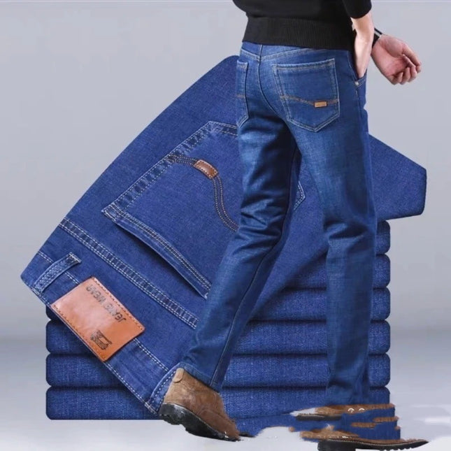 Stack of blue jeans with a person wearing them on a gray background