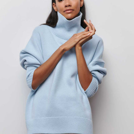 Woman wearing a light blue sweater against a plain background