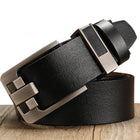 Black leather belt with a silver buckle on a wooden surface