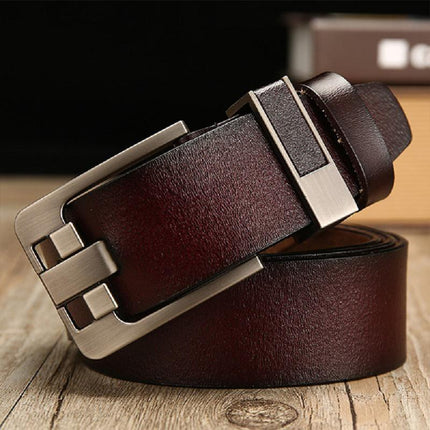 Brown leather belt with a silver buckle on a wooden surface