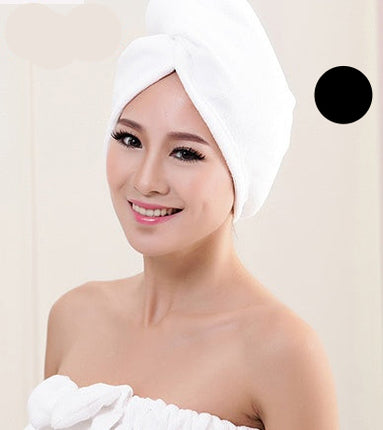 Woman with a white towel wrapped around her head and shoulders