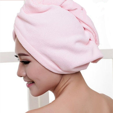 Woman wearing a pink towel on her head.