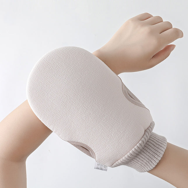 Light pink mitt on a hand against a light gray background