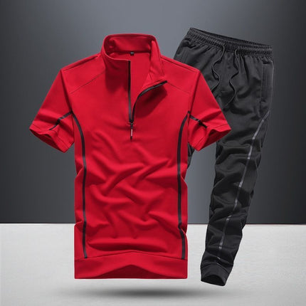 Red athletic shirt with black accents and black pants on a gray background