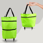 Green shopping bag with black straps and wheels on a gray background