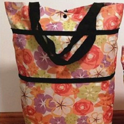 Floral-patterned tote bag with black handles on a plain background