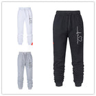 Set of three jogger pants in black, white, and gray with a brand logo on a white background.