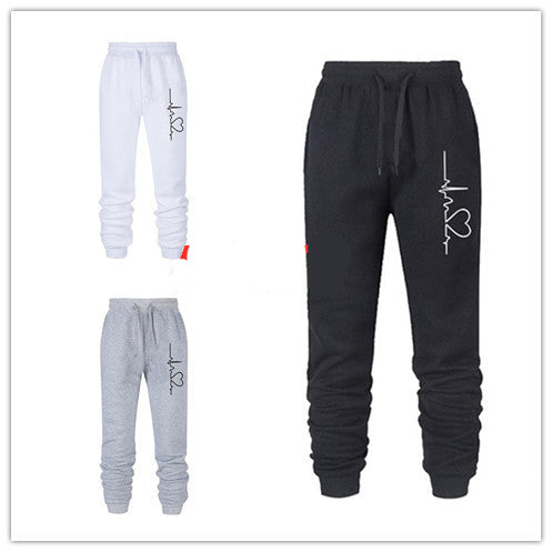 Set of three jogger pants in black, white, and gray with a brand logo on a white background.