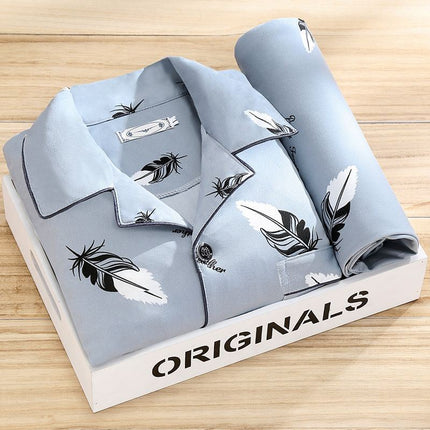 Folded gray shirt with feather pattern on a branded box