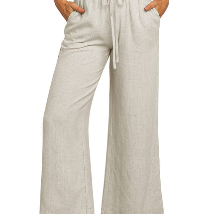Beige wide-leg pants worn by a person on a white background