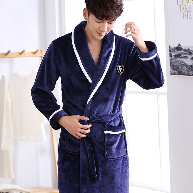 Person wearing a navy blue robe with white trim in a room setting.