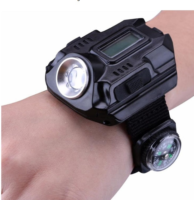 Wrist-mounted flashlight with digital display and compass on a white background