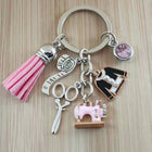 Keychain with sewing-themed charms on a wooden surface