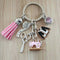 Keychain with sewing-themed charms on a wooden surface