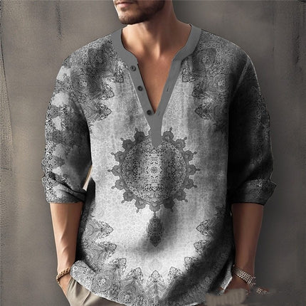 Man wearing a patterned shirt with a neutral background