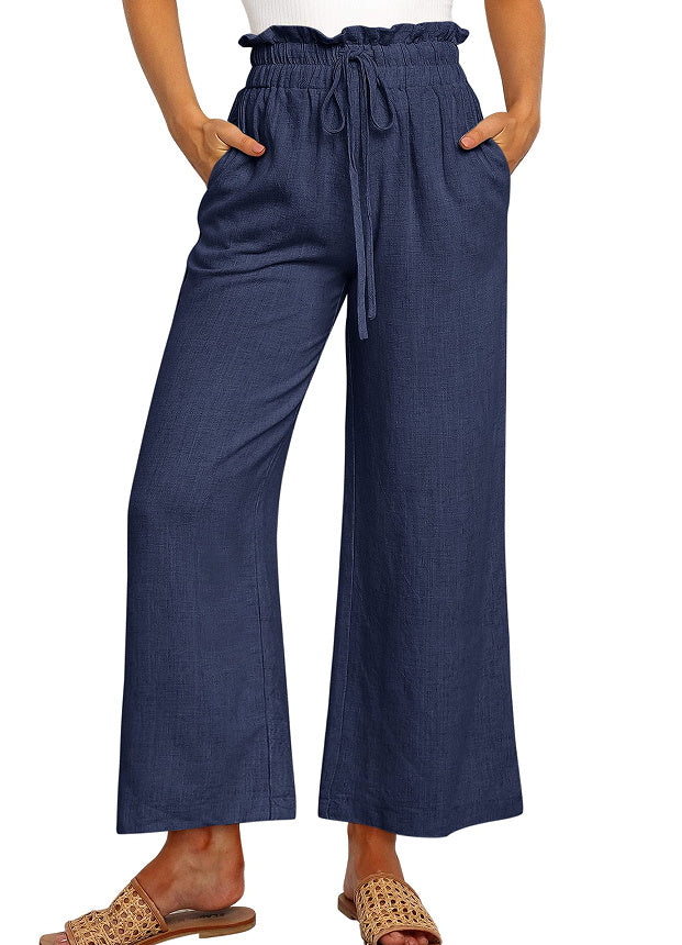 Navy blue wide-leg pants worn by a person on a white background