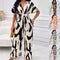 Woman wearing a black and white patterned dress in an indoor setting.