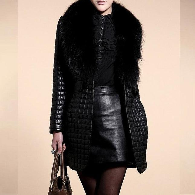 Person wearing a black coat with fur collar and leather skirt on a beige background