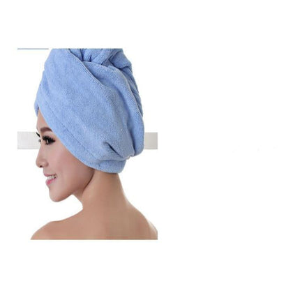 Woman wearing a blue towel on her head against a white background