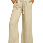 Beige wide-leg pants with a drawstring waist on a white background