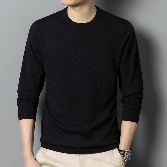 Person wearing a black long-sleeve shirt against a gray background