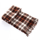 Plaid blanket with brown, white, and orange colors on a white background