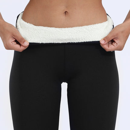 Person wearing black leggings with white waistband on a plain background