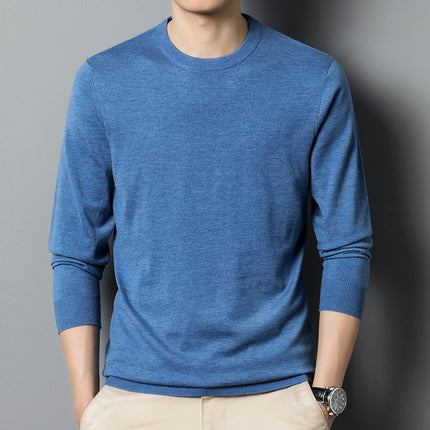 Person wearing a blue long-sleeve shirt against a gray background
