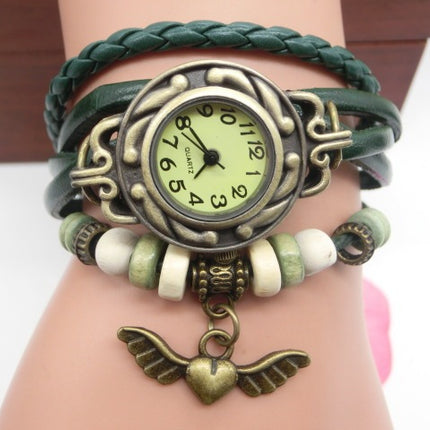 Bracelet with vintage-style watch and angel wing charm on wrist