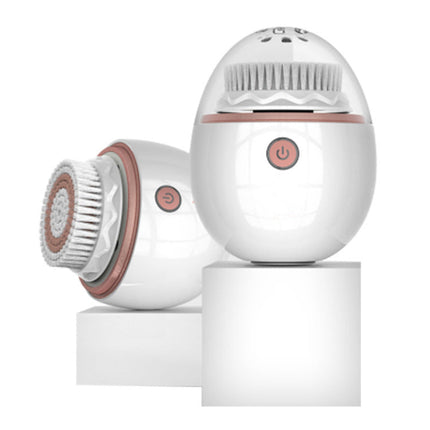 White and rose gold facial cleansing device 
