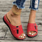 Red sandals worn on a wooden floor