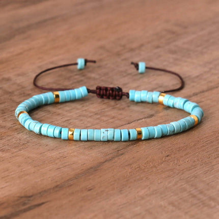 Hand-woven turquoise bead bracelet with gold accents, adjustable design for women.