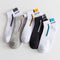 Set of five pairs of socks with 'Sport' branding on a light gray background