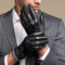 Man wearing black leather gloves with a gray suit jacket.