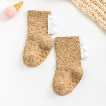 Pair of beige baby socks with white ruffles on a white background