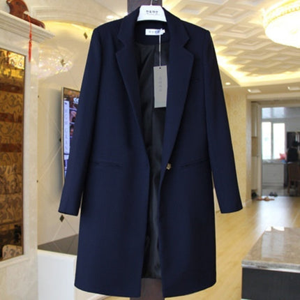 Navy blue coat displayed in a store with a blurred interior background
