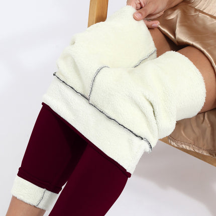 Person wearing maroon leggings with white leg warmers on a white background