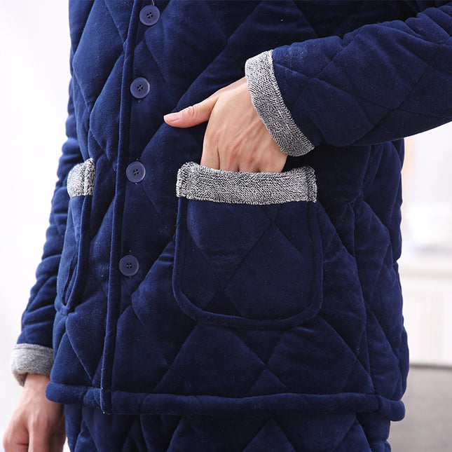 Navy blue quilted coat with gray cuffs and trim on a blurred background